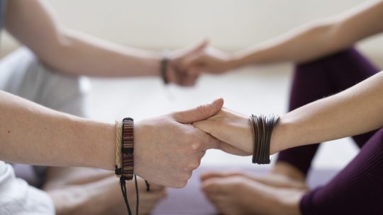 spiritual-young-man-woman-practicing-yoga-indoors